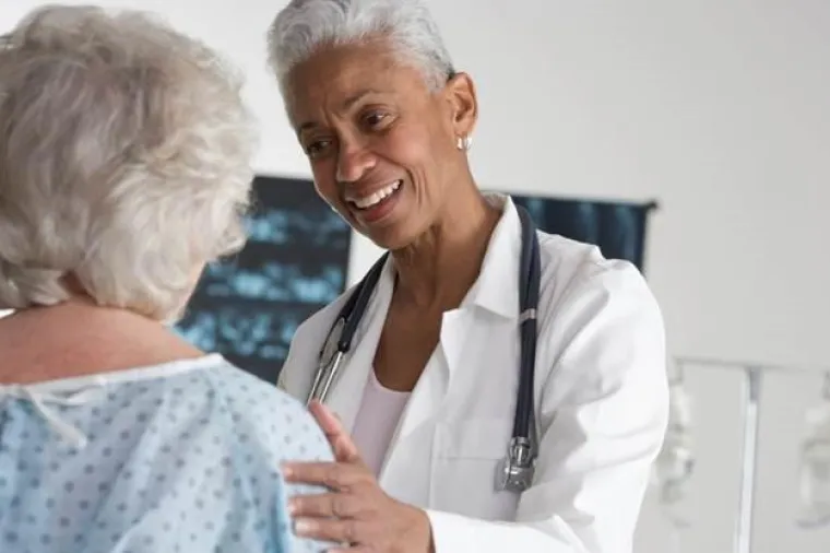 Elder Care image showing a doctor talking to an elderly lady